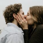 couple kissing under gray clouds