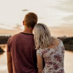 man and woman standing on brown field during daytime