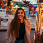 smiling woman wearing brown coat