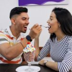 man and woman about to feed each other