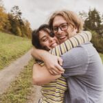 man and woman hugging near trees