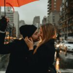 woman in black jacket holding red umbrella during daytime