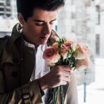 man holding pink roses