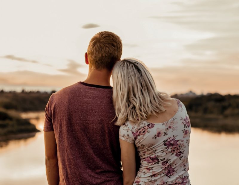 man and woman standing on brown field during daytime